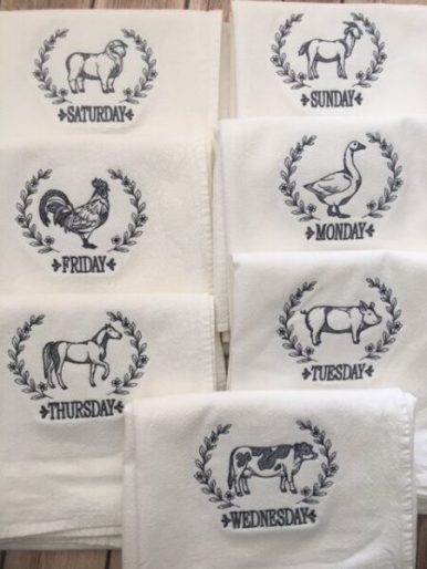 Set of 7 towels featuring a different farm animal for each day of the week.  Approximately 30 x 30 inches in size.  Hemmed on all 4 sides. Embroidered with dark gray thread.