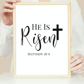 He Is Risen Calligraphy style with cross, white background written in black. in wooden portrait frame mockup