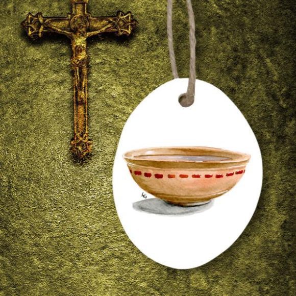 Wash Basin Resurrection Easter Ornament on green background next to crucifix