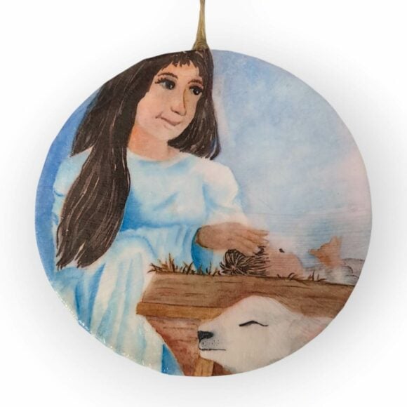 Round ornament with Mother Mary stroking Jesus's head in manger