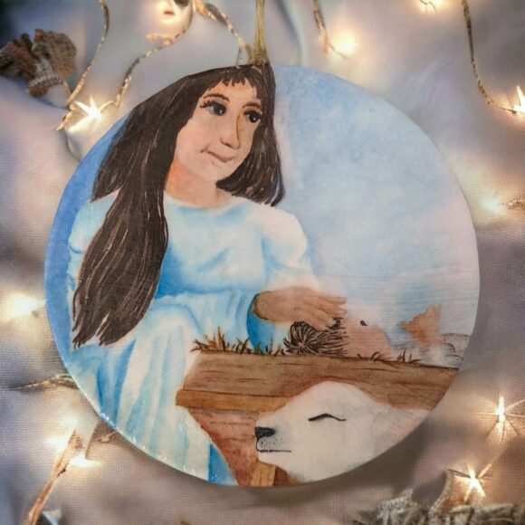 Mary and Baby Jesus ornament with white Christmas lights background