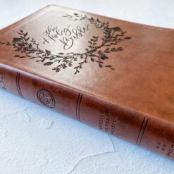 A ESV Wide Margin by Crossway Publishing in Brown. It has a design of The Holy Bible in a Wreath engraved on it. It is hand lettered with calligraphy and makes a beautiful Christian gift, Gods Word, Scripture, 9781433544163