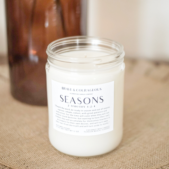 Embrace the warmth of fall with the Seasons Candle. Featuring cinnamon, citrus, apple, and cedarwood, this Christian candle is paired with 2 Timothy 4:2-4. Perfect for cozy autumn nights, Bible verse gifts, and Christian home decor. Made with clean coconut wax for a long-lasting, soothing aroma.