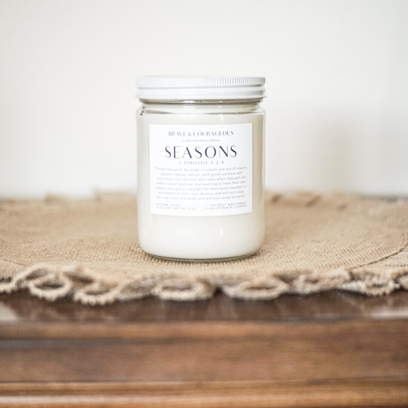 Embrace the warmth of fall with the Seasons Candle. Featuring cinnamon, citrus, apple, and cedarwood, this Christian candle is paired with 2 Timothy 4:2-4. Perfect for cozy autumn nights, Bible verse gifts, and Christian home decor. Made with clean coconut wax for a long-lasting, soothing aroma.