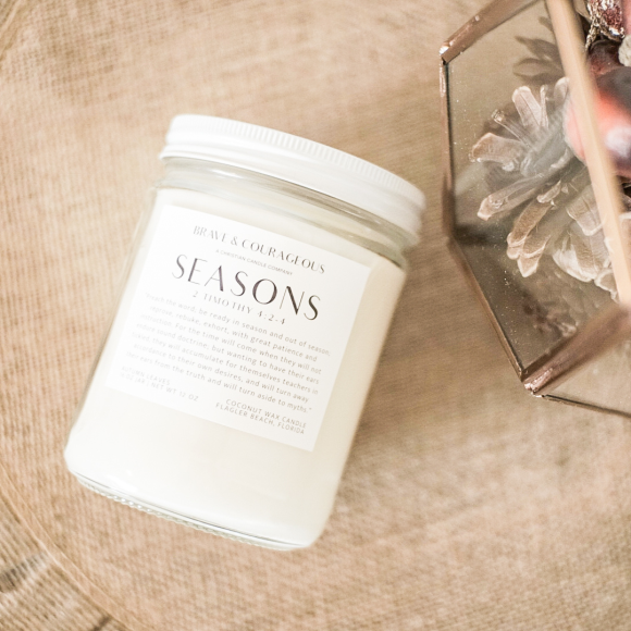 Embrace the warmth of fall with the Seasons Candle. Featuring cinnamon, citrus, apple, and cedarwood, this Christian candle is paired with 2 Timothy 4:2-4. Perfect for cozy autumn nights, Bible verse gifts, and Christian home decor. Made with clean coconut wax for a long-lasting, soothing aroma.