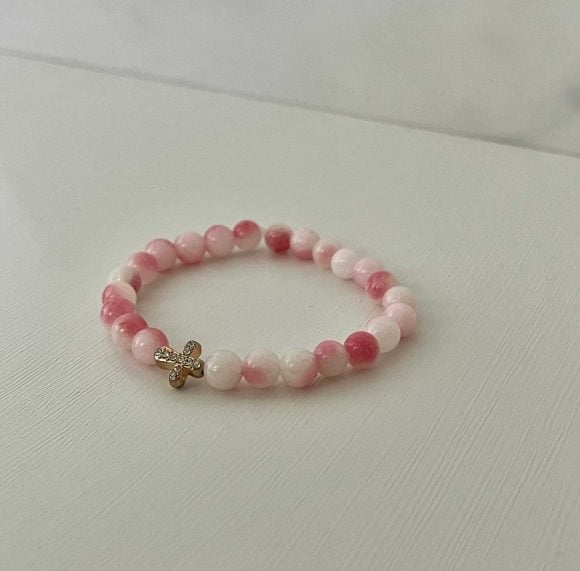 Pink white marble cross bracelet, handmade Christian jewelry, features a gold cross charm, perfect faith-inspired gift or daily accessory.